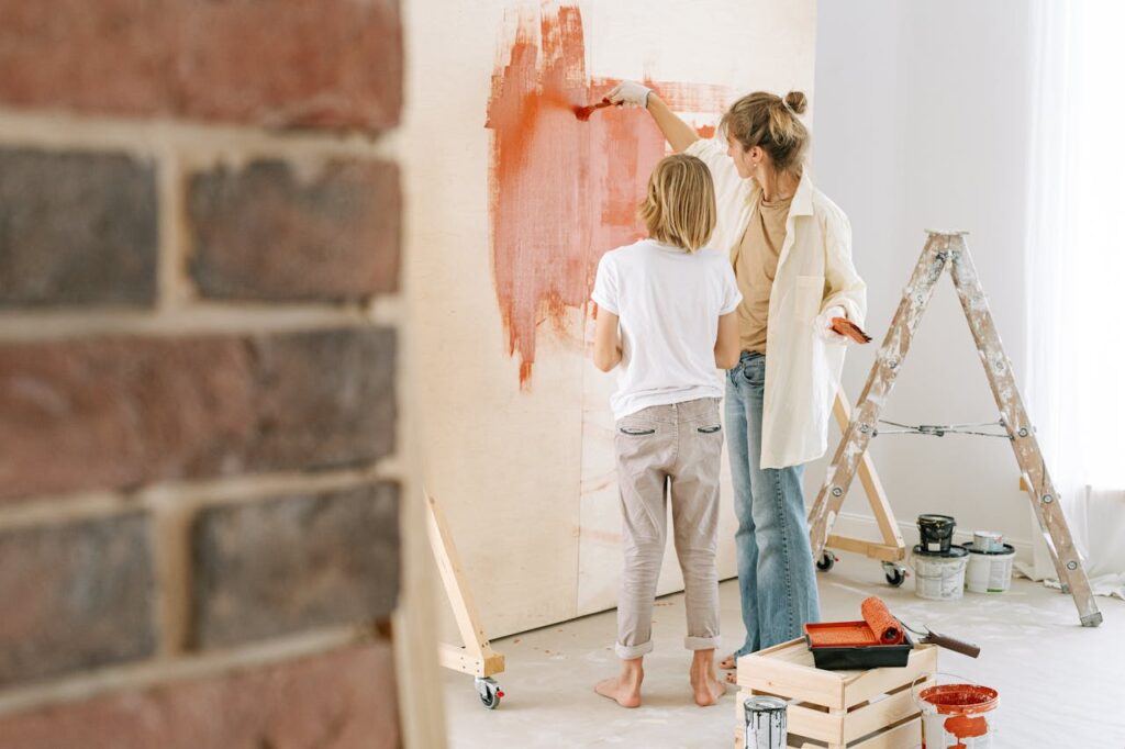 A Woman Painting a Wall